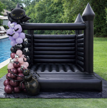 White bounce house in elegant garden setting